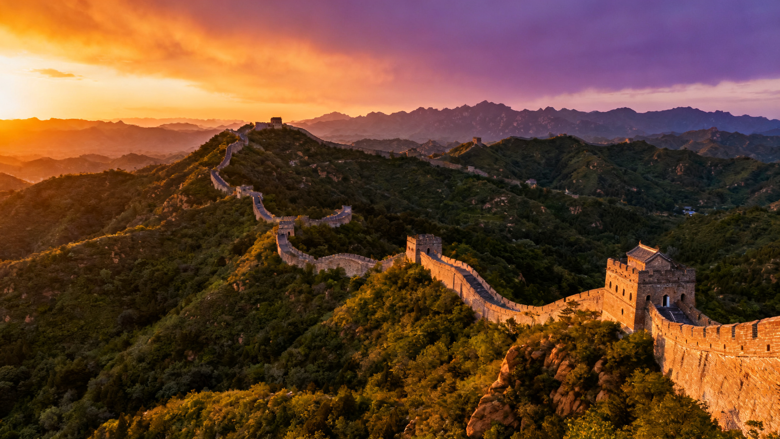 The Great Wall winding through the mountains at sunset